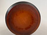 a brown vase sitting on a table with a white background