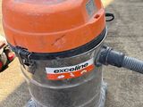 an orange and black vacuum cleaner sitting on top of a cement floor