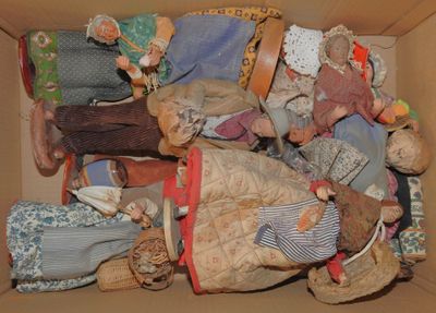 a cardboard box filled with many different types of dolls