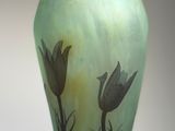 a glass vase with flowers on it on a table