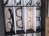 many pairs of glasses on display in a display case