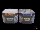 two boxes of pokemon trading cards on a black background