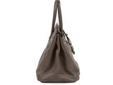 the large brown bag is sitting on a white surface