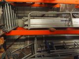 a large rack with many items in it in a warehouse