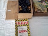 two boxes of chess pieces and a book on a table