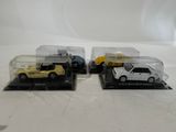 three toy cars are in a display case on a white surface