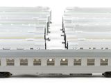 a white train that is sitting next to a stack of boxes