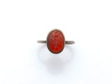 l'image d'une bague contenant une pierre rouge