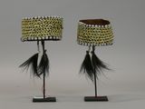 pair of african beaded lamps with black and white feathers on stands