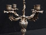 a silver candelab that is sitting on a table