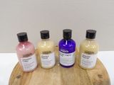 several bottles of different types of hair products sitting on a wooden tray
