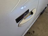 a close up of a car door handle with a sticker on it