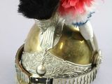 a silver helmet with a red flower on it