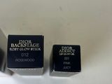 two lipsticks sitting on top of a white table next to each other