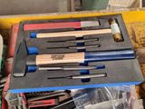 many different tools in the box on the table