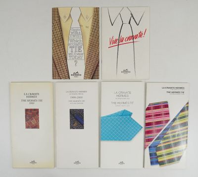 four books on a white wall with a tie, shirt, tie, and other items