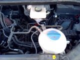 a toilet in the engine bay of a car