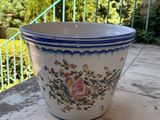 a blue and white flower pot sitting on a table