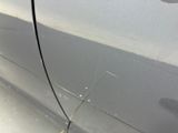 a close up of a car ' s side door with a crack in it