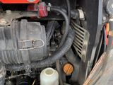 a close up of a car engine with the hood open
