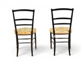 two black chairs with a yellow seat and a yellow cushion