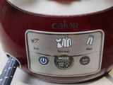 a close up of a red and white blender on a counter