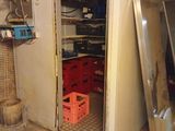 a white refrigerator in a room with a lot of shelves