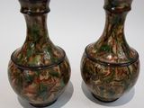 two vases sitting next to each other on a table