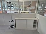 an image of an office cubicle with a desk and a chair