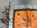 a piece of cloth with a design of birds on it