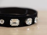a black leather bracelet with crystal stones on it
