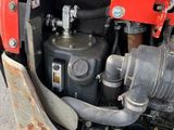 a close up view of a car engine with the hood open
