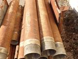 a pile of pipes sitting on the ground next to a building