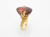 an image of a ring with a large brown stone in it