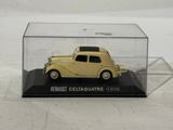 yellow model car in a clear case on a white surface