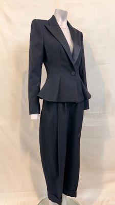 a mannequin wearing a suit and tie on a mannequin stand