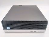 the back of a computer with a keyboard and mouse on a white surface