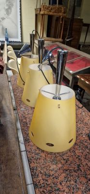 three lamps that are sitting on a counter top