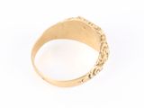 a close up of a gold ring on a white background