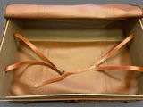 a brown suitcase with a brown strap in it