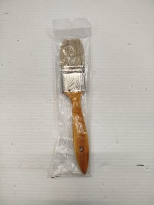 a paint brush in a plastic bag on a table