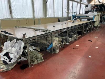 a long table that has a bunch of bags on it