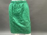 a mannequin mannequin wearing a green skirt and white top
