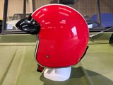 a red helmet sitting on top of a green truck