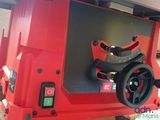 a red table saw with a black handle on it