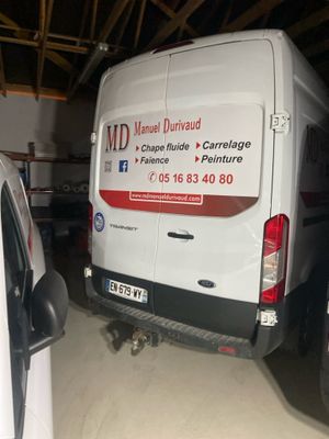 a van that is parked in a garage next to another van
