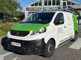 a green and white van parked in front of a building