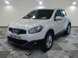 the white nissan qxv is parked in a room with a checkered floor