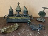 a table topped with a clock and other antique items