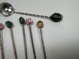 five spoons that are sitting on a table